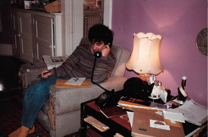 Gary Topp sitting in a chair on the phone in his home office