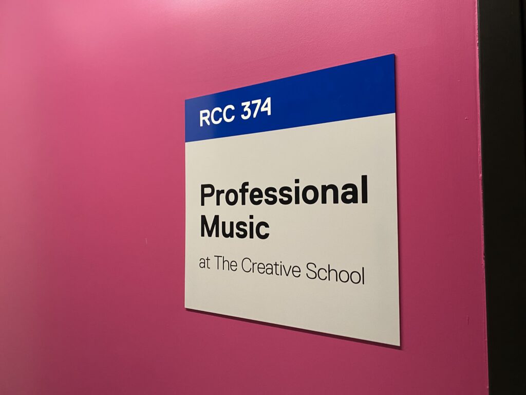 Professional Music sign on pink wall. 